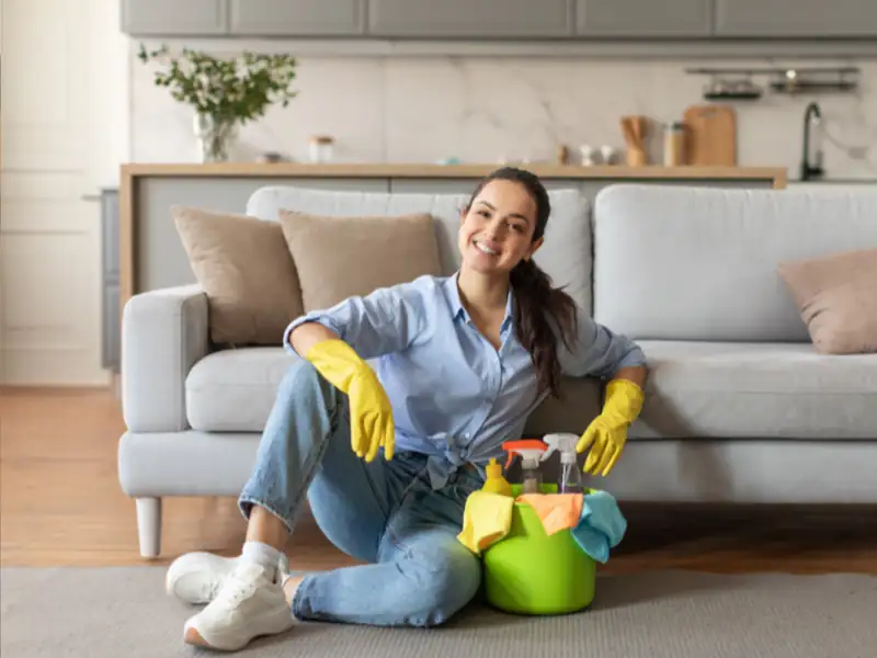 Happy woman sitting in a freshly cleaned living room before Diwali