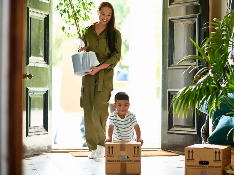 Family moving into a freshly cleaned house in Indore with cardboard boxes